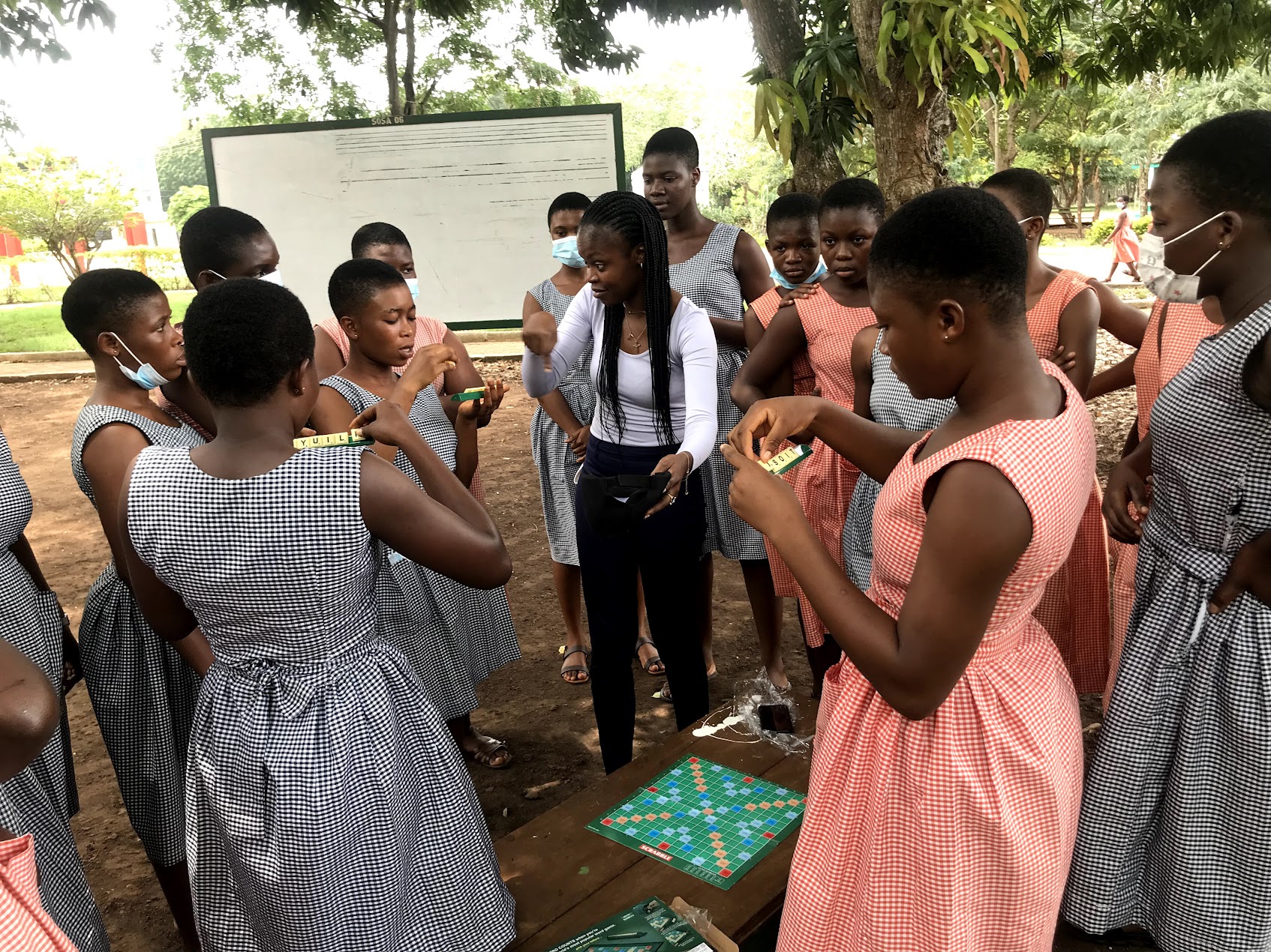 Participants playing a word game with a mentor at a past Mesrenyame & FRIENDS event